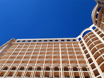 Low angle view of building against clear blue sky