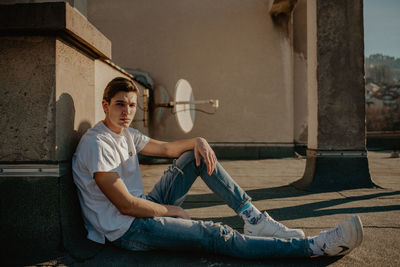 Portrait of young man sitting outdoors