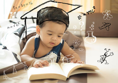 Digital composite image of toddler reading book at home