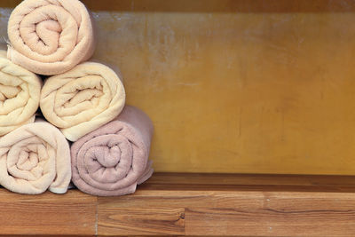 Close-up of rolled up towels on shelf at spa