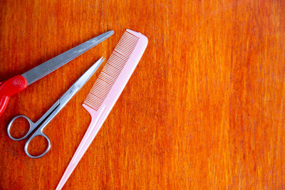 High angle view of wooden table against orange background