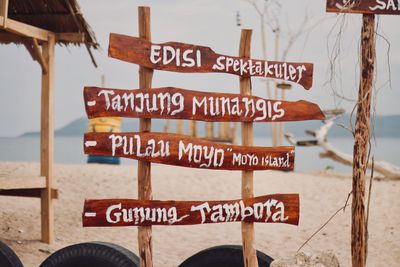 Close-up of information sign on beach