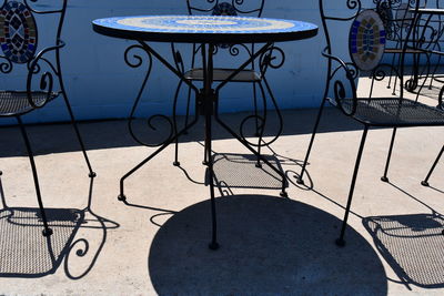 High angle view of empty chair against wall