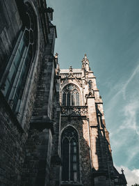 The dance of shadow and light with the low-angle shot of a church against the sky.