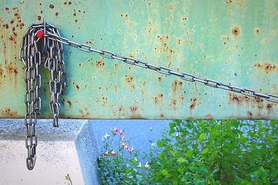 Close-up of rusty metal chain against wall