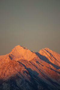 Scenic view of snowcapped mountains against clear sky