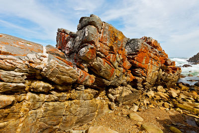 Low angle view of rock formation against sky