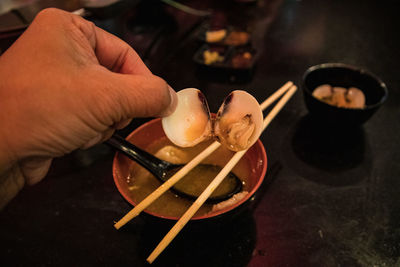 Cropped hand of man holding food