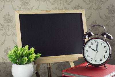 Close-up of clock on table