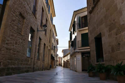 Narrow alley amidst buildings in city