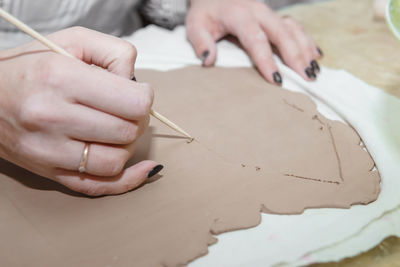Close-up of hands working on table