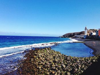 Scenic view of sea against clear blue sky