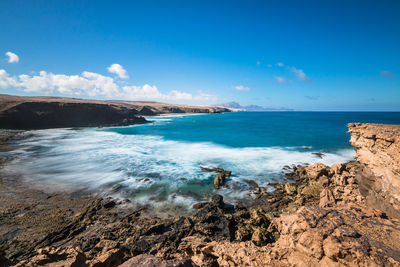 Scenic view of sea against blue sky