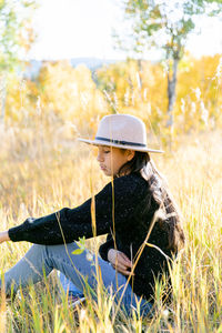 Rear view of woman standing on field