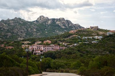 Townscape by mountain against sky