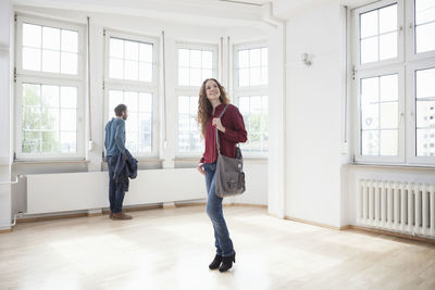 Couple looking around in empty apartment