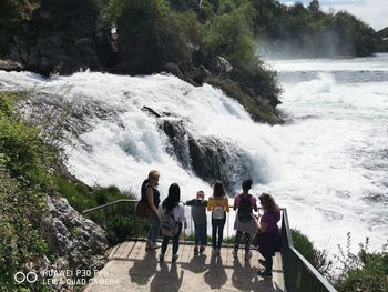 People looking at waterfall