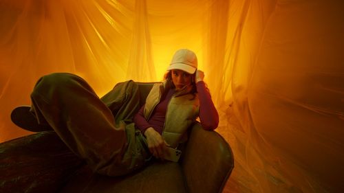 Portrait of woman sitting on sofa at home