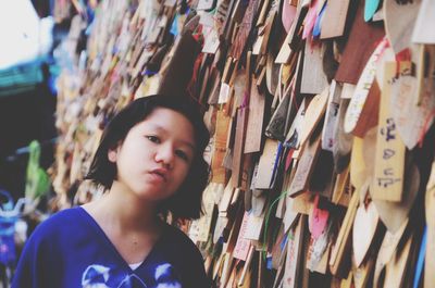 Portrait of girl standing by prayer blocks