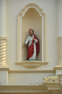 Statue of buddha against building
