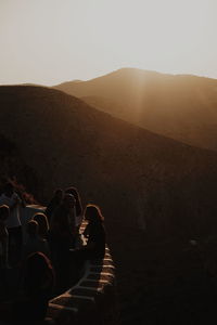 People on mountain during sunset