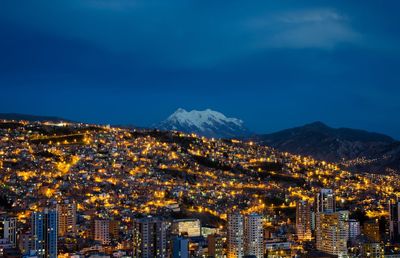 Aerial view of city lit up at night