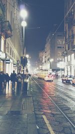 Illuminated city street at night
