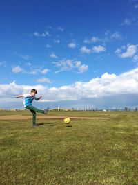 Scenic view of field against cloudy sky