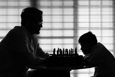 Silhouette of man playing chess
