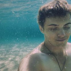 Portrait of young man underwater in pool