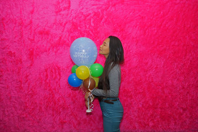 Person with balloons on pink balloon