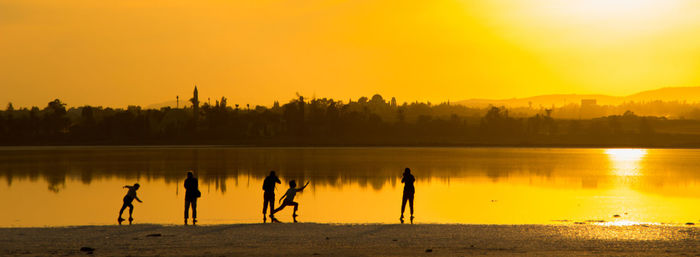 Scenic view of lake at sunset