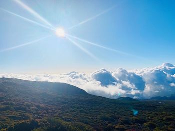 Scenic view of landscape against sky on sunny day