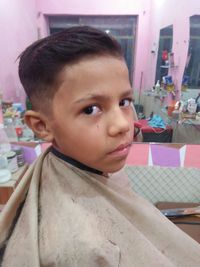 Close-up portrait of cute boy at home