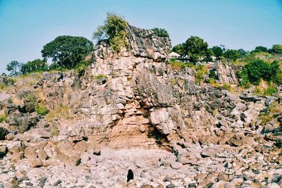 Low angle view of rocks against blue sky