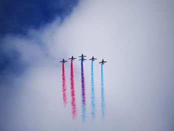 Low angle view of airplane flying against sky