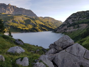 Scenic view of lake and mountains against sky