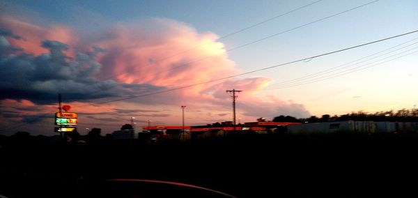 Silhouette buildings against sky during sunset