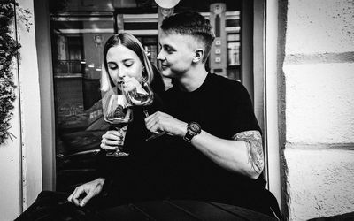 Young man drinking glass on table