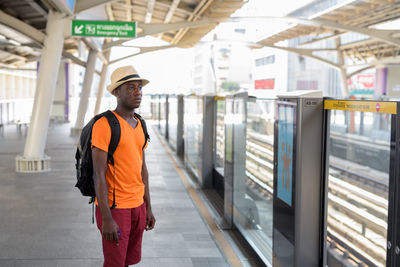 Full length of man standing at railroad station