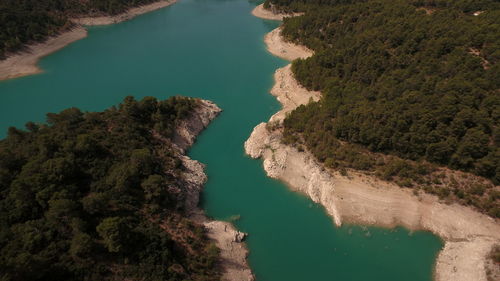 High angle view of river amidst trees against sky