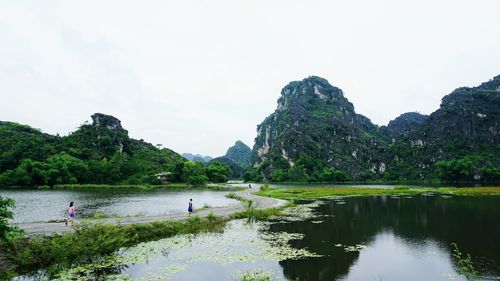 Scenic view of lake and mountains against clear sky