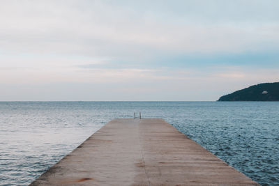 Pier over sea against sky