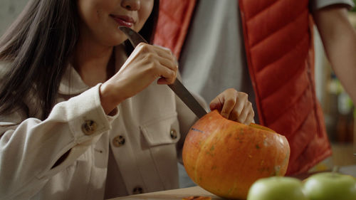 Midsection of woman holding apple