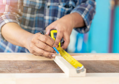 Midsection of man working in workshop