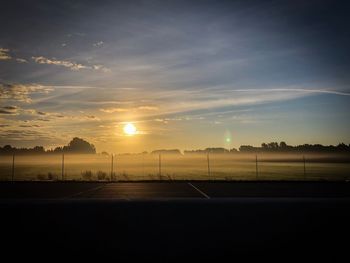 Scenic view of field against sky during sunset