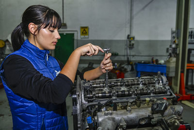 Side view of young man working at workshop