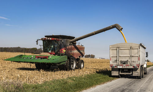 Tractor on farm against sky