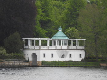 Building by lake in forest