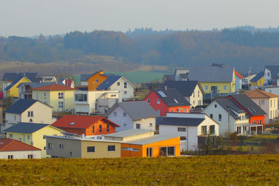 High angle view of houses by buildings in town